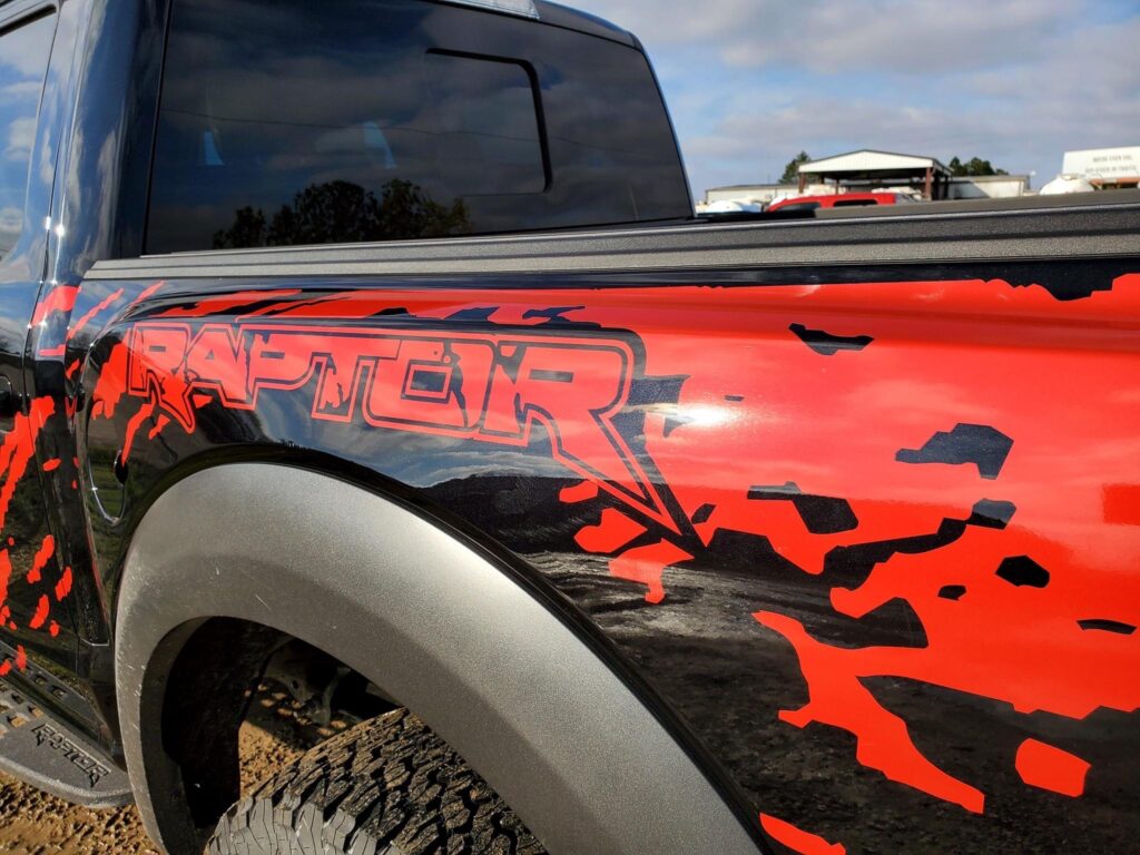 Ford Raptor cut vinyl. Digital mud. Dragon blood red graphics. 3M 1080 gloss. Ford Raptor wrap.